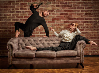 Female ballet dancer and male latin dancer in contemporary style drinking champagne