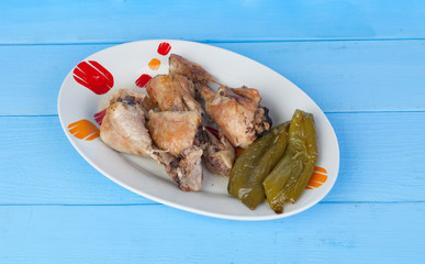 Source of chicken thighs with baked peppers