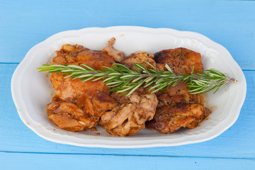 Source of chicken in sauce with a sprig of rosemary