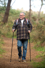 Portrait of a healthy senior attractive man hiking along the cost