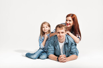 Fototapeta na wymiar Happy funny family portrait lying on white background isolated