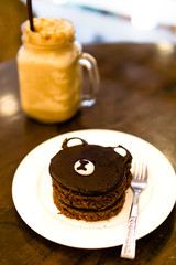 Cake bears face with cool coffee on the table.Suitable as a dessert for snacks.