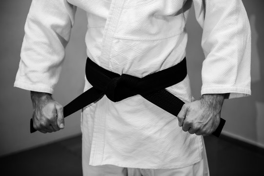 Aikido black belt on white kimono