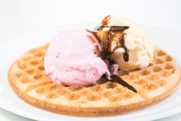 Vanilla and strawberry ice cream on a waffle