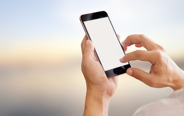 BusinessMan holding smart phone with blurred backgroung. Blank screen for Graphic display montage.