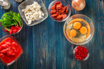 Ingredients for preparing frittata - eggs, sausage chorizo, red