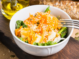 Colorful vegetable salad bowl for lunch on wooden rustic background