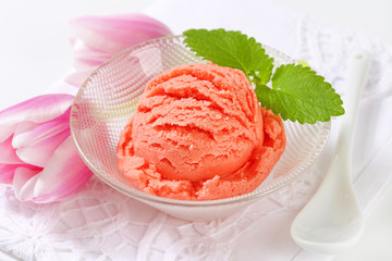 Scoop of pink ice cream in bowl