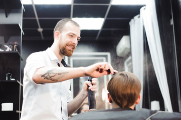 cute young boy getting a haircut