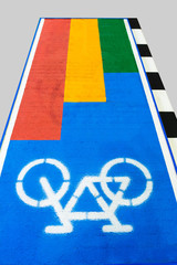 White bicycle icon on blue bicycle lane on gray background