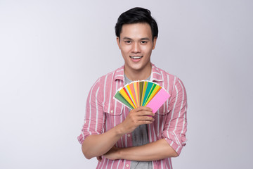 Young asian graphic designer holding color palette