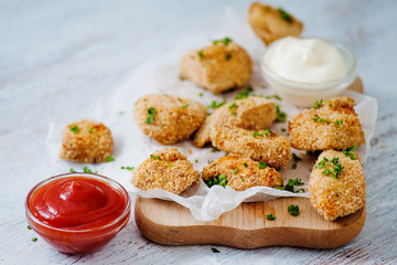 Delicious nuggets served on the board with two sauces