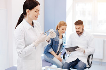 Obraz premium Joyful pleasant woman assisting in the doctors office