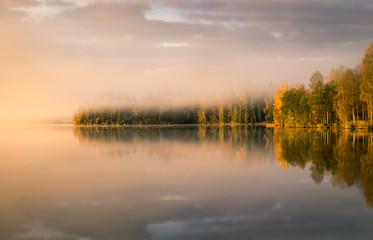 Scenic landscape with lake and fall colors at morning light