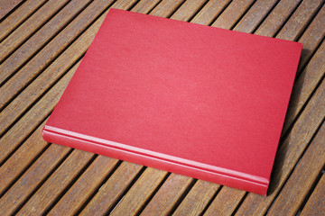Red book on the outdoor wooden table at coffee shop