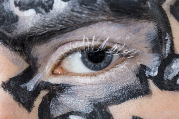 detail of female eye with painted face