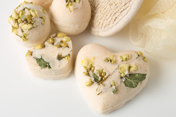 Fototapeta na wymiar Bath bombs decorated with dried linden flowers on a white