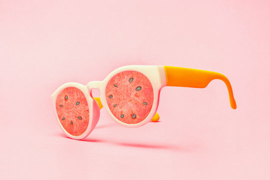 Beach sunglasses concept with watermelon on pink background