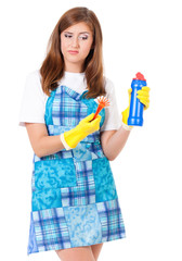 Tired young woman holding bottle of chemistry for cleaning house. Cleaning concept. Beautiful girl with cleaning tools and products on white background. Housekeeper isolated portrait.