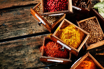 Small wooden drawers filled with assorted spices