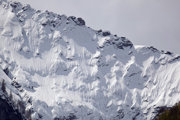 North face of mountain side covered in snow