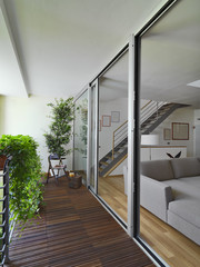 balcony with wood floor overlooking on the modern living room