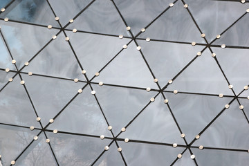Fragment of transparent roof of glass triangles. Abstract architectural background