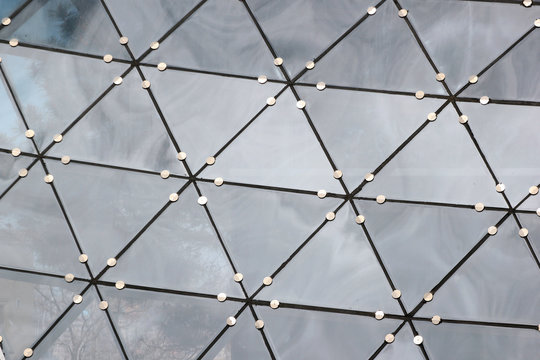 Fragment of transparent roof of glass triangles. Abstract architectural background