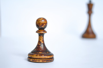 Old chess Board with wooden pieces on a white background