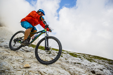 Fototapeta na wymiar View of cyclist riding mountain bike on trail in Dolomites,Tre Cime di Laverado, South Tirol, Italy