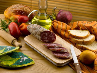 salami and slices on a cutting board in the kitchen