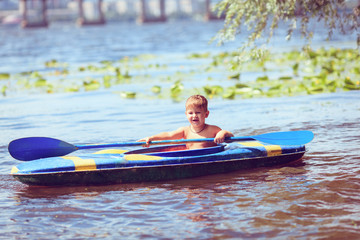 Young people are kayaking on a river in beautiful nature.