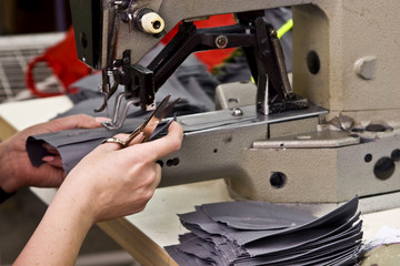 A girl sews clothes at a sewing factory