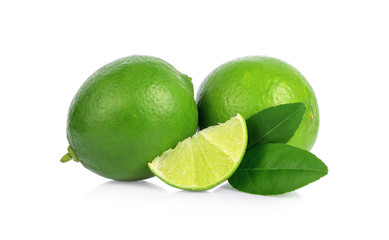 Two whole lime fruits and a piece with leaves isolated on white background
