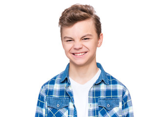Teen boy making silly grimace - expressing disgust face. Upset child isolated on white background....