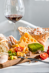 Wine, baguette and cheese on wooden background