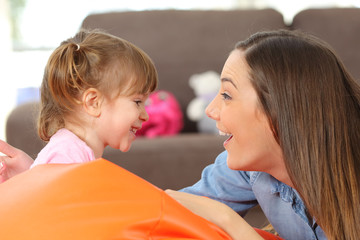 Mother and baby daughter facing
