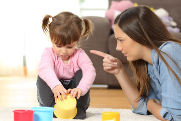Mother scolding to her baby daughter