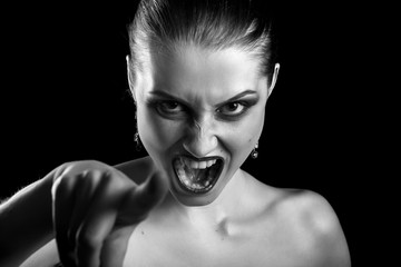 angry beautiful woman point at camera screaming, monochrome