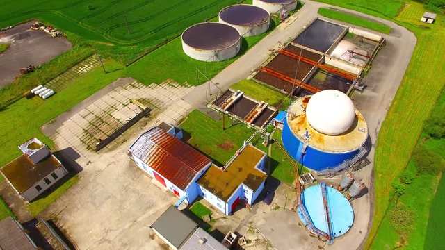 Camera flight over biogas plant from pig farm. Renewable energy from biomass. Modern agriculture in Czech Republic and European Union. 
