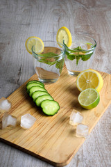 Water with lemon,lime  mint and cucumber on the wooden dark background. Water Detox.on wooden background