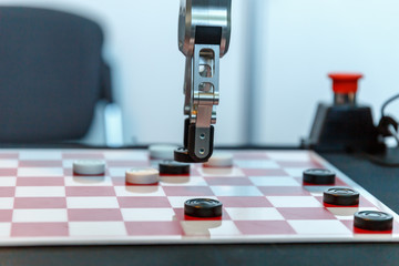 High-tech robot plays checkers at an exhibition of robotics