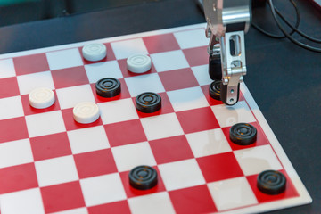 High-tech robot plays checkers at an exhibition of robotics
