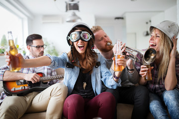 Happy young friends having fun and partying to music