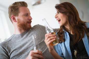 Young beautiful couple flirting and smiling at home