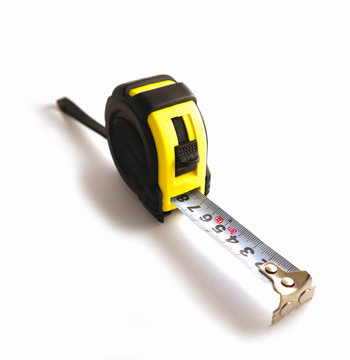 Photo depicts an image of ruler tool measuring centimeters, isolated on a white background. Professional yellow measure tape, engineering tool. Close up, top view.