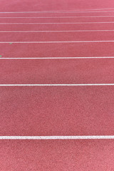Fototapeta premium Athletics stadium running track red lines marks