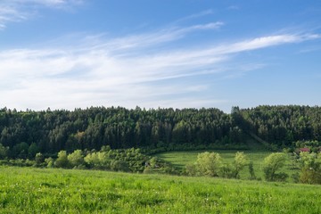 Fototapeta premium Dramatic clouds on a green meadow, sunrise and sunset in nature. Slovakia