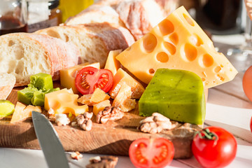 The baguette and cheese on wooden background