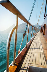 Boat in the azure clear sea near the paradise island. Yacht in the ocean.
